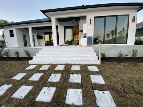 Rear covered lanai with wide steps and stepping-stone path