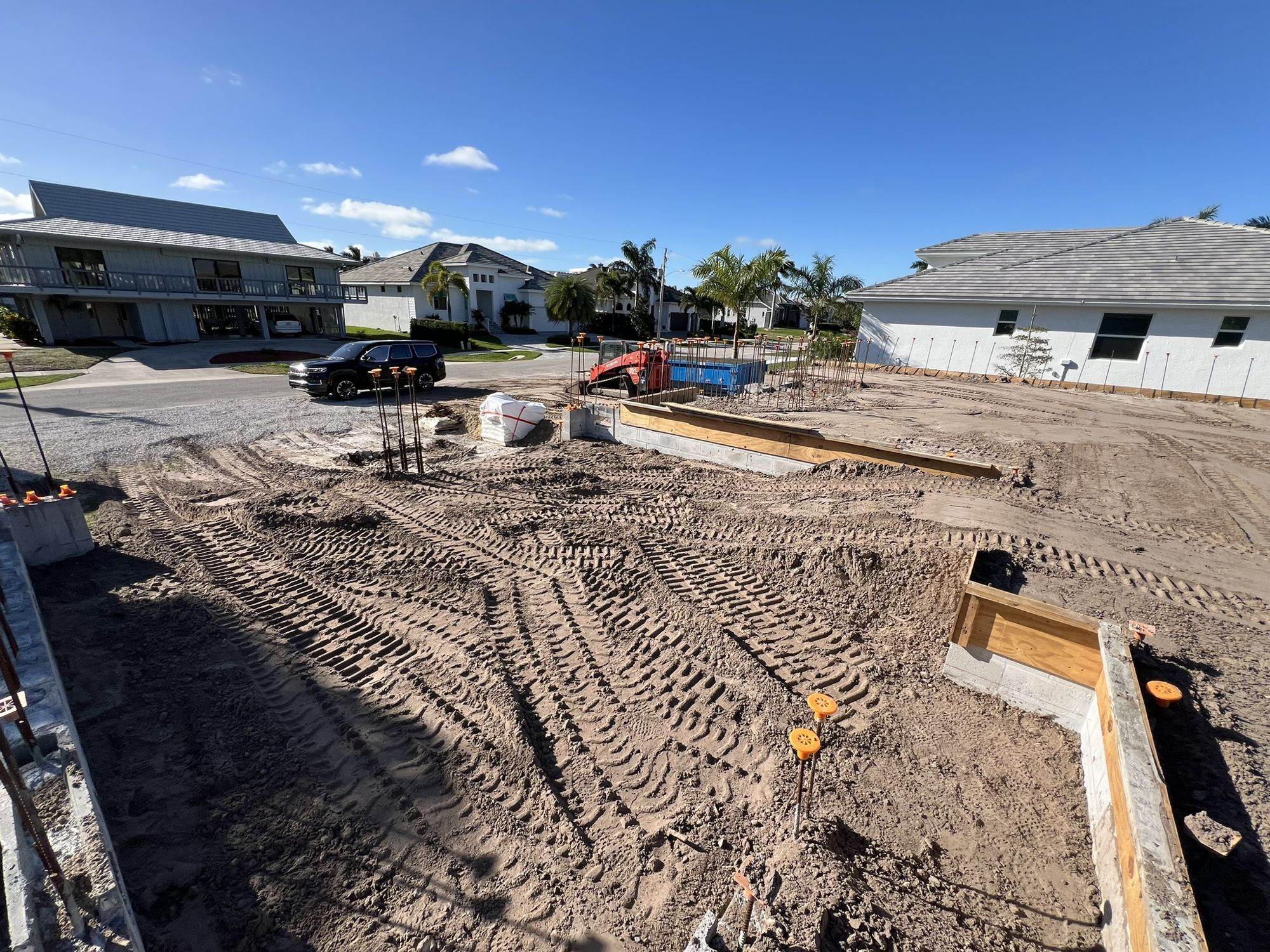 Cleared lot with footings, block and rebar in place