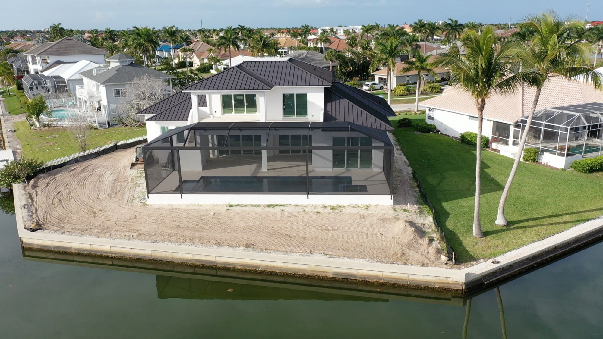 Whiteheart Court, a new two-story home with screened pool on a Marco Island canal, built by MY Castellano Group